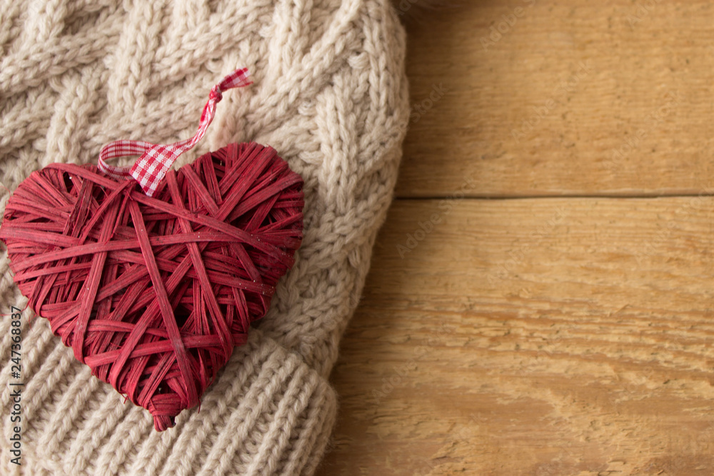 The Valentine Day Concept. Wicker red heart top on the winter hat. Copy space area
