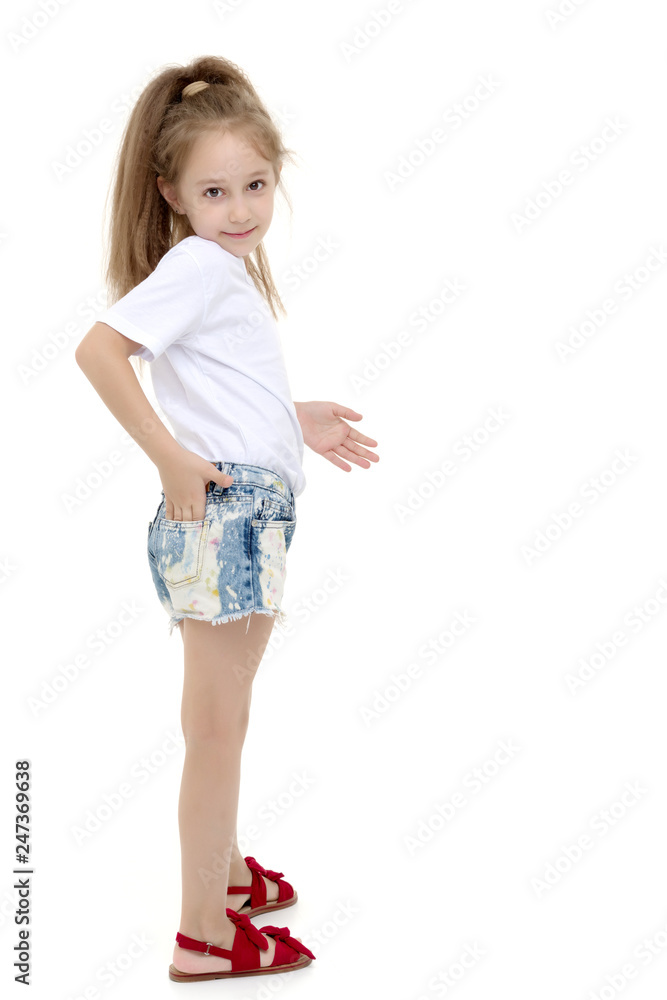 Little girl in a pure white t-shirt for advertising and shorts. Little girl in a pure white t-shirt for advertising and shorts.