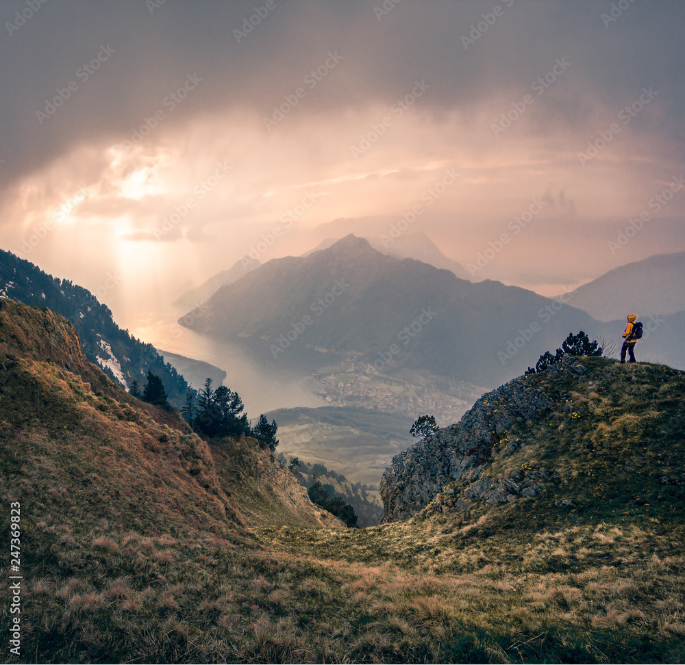 A person looking on a sunset in mountains 