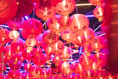 many chinese lanterns hang on the top ceiling made with rope at night