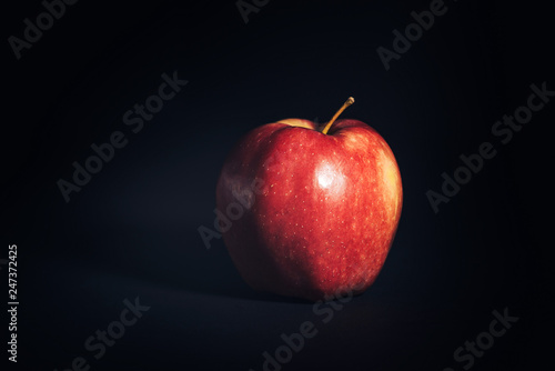 Red ripe Apple on black background.