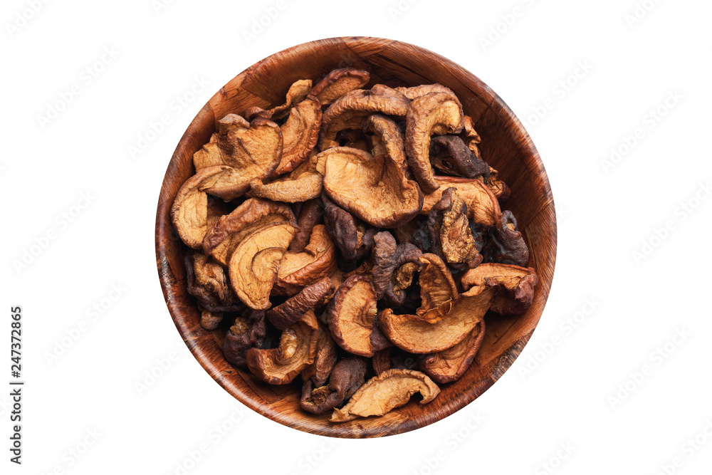 Dry apple fruit in wooden bowl. Sweet and healthy snack isolated on white. Empty copy space diet background.