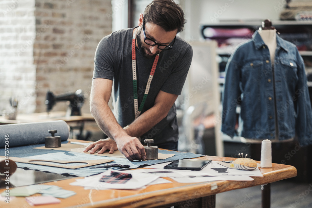 Fashion designer working in his studio Fashion designer working in his studio