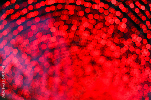 Red, pink and black bokeh at night time.