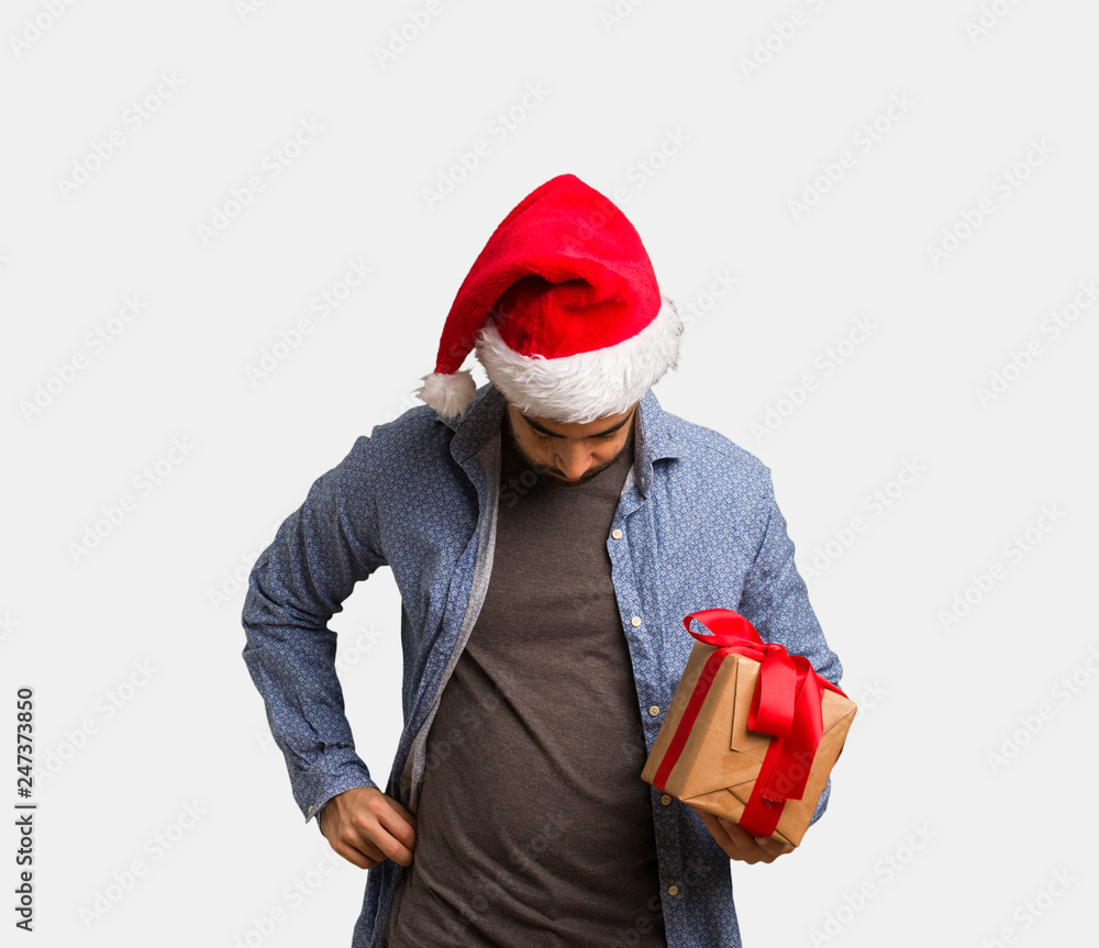Young man wearing santa hat showing number eight Young man wearing santa hat showing number eight