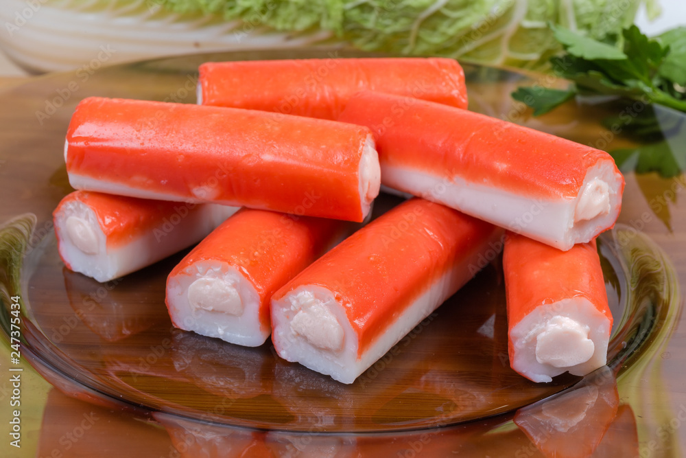 Stuffed crab sticks on dark glass dish close-up Stuffed crab sticks on dark glass dish close-up