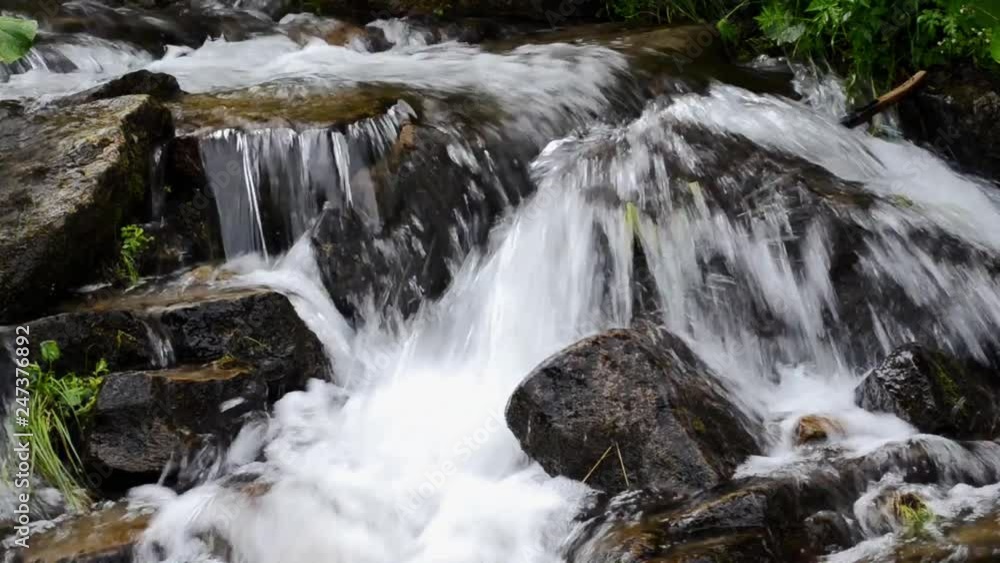 small waterfall in the mountains with clear water small waterfall in the mountains with clear water