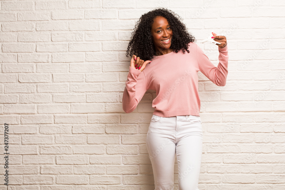 Young black woman proud and confident, pointing fingers, example to follow, concept of satisfaction, arrogance and health Young black woman proud and confident, pointing fingers, example to follow, concept of satisfaction, arrogance and health