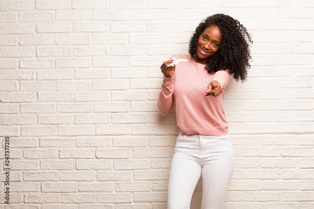 Young black woman cheerful and smiling pointing to the front Young black woman cheerful and smiling pointing to the front