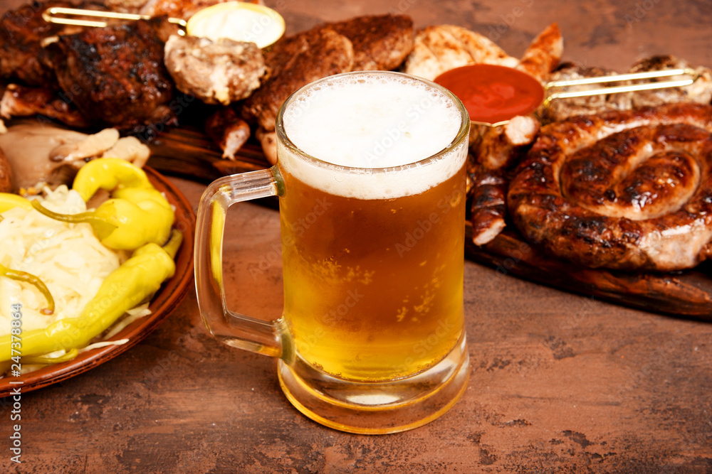 Meat barbecue set on the table. Sausages, pork, mushrooms, beef, sauces, pickles. Beer snacks. Meat barbecue set on the table. Sausages, pork, mushrooms, beef, sauces, pickles. Beer snacks.