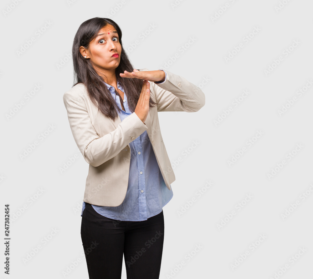 Young business indian woman tired and bored, making a timeout gesture, needs to stop because of work stress, time concept Young business indian woman tired and bored, making a timeout gesture, needs to stop because of work stress, time concept