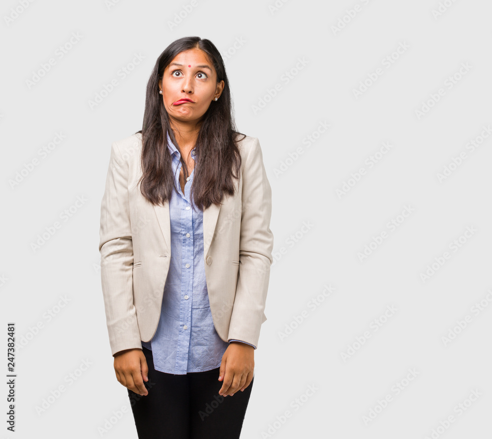 Young business indian woman crazy and desperate, screaming out of control, funny lunatic expressing freedom and wild Young business indian woman crazy and desperate, screaming out of control, funny lunatic expressing freedom and wild