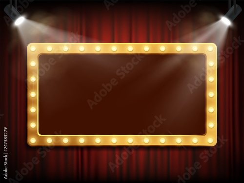 Gold frame with light bulbs on red velvet curtain.