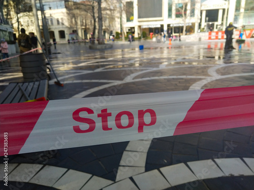 Wallpaper Mural Process of urban street cleaning.  Wet cleaning of street with water and stop sign Torontodigital.ca