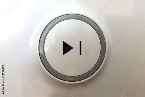 Button play black on a white background in a circle close up