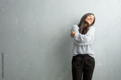 Young indian woman against a grunge wall proud and confident, pointing fingers, example to follow, concept of satisfaction, arrogance and health © Asier