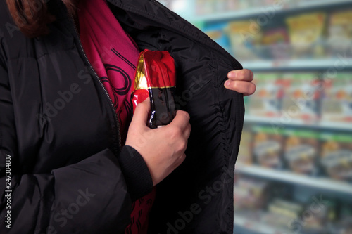 Woman shoplifting in a store photo