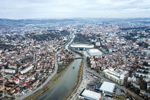 Aerial above view of river crossing the city