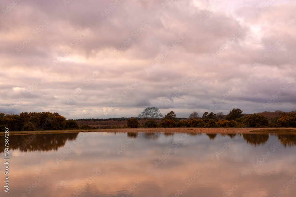 Stormy clouds over lake in New Forest countryside