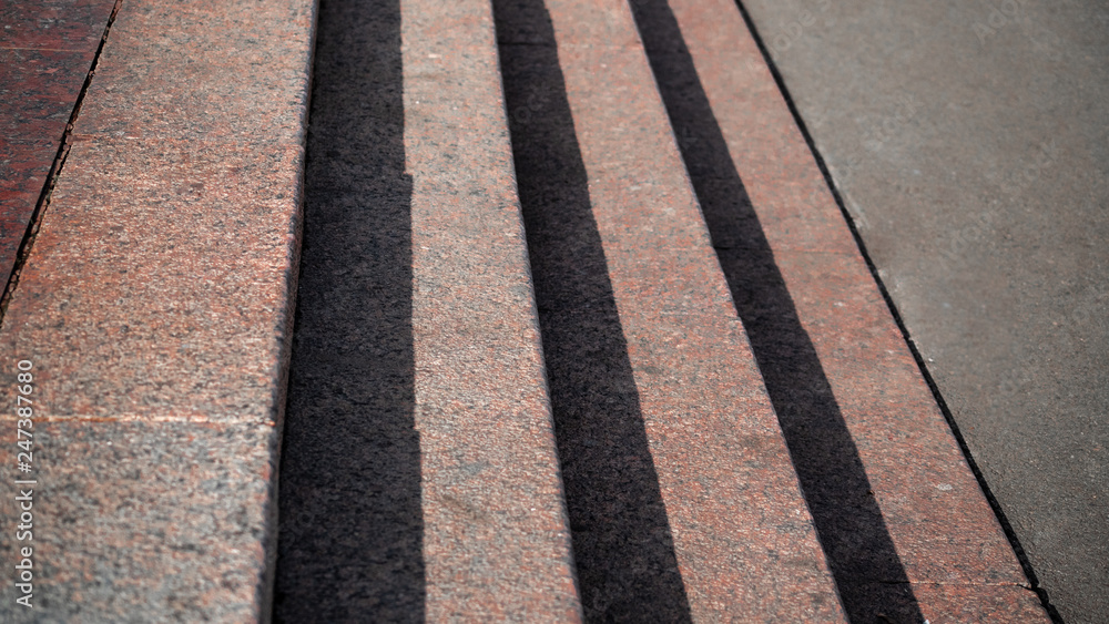 Obraz premium Horizontal view of shadows projected on the granite stairs