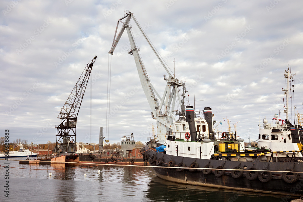 Tugboats and other marine support vessels in port.