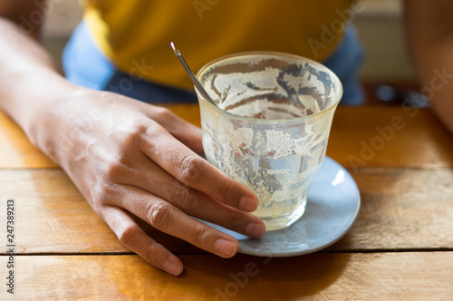 Woman holding empty coffee cup.