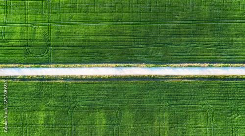 Aerial view at the road and field. Agricultural landscape from air. Field and...