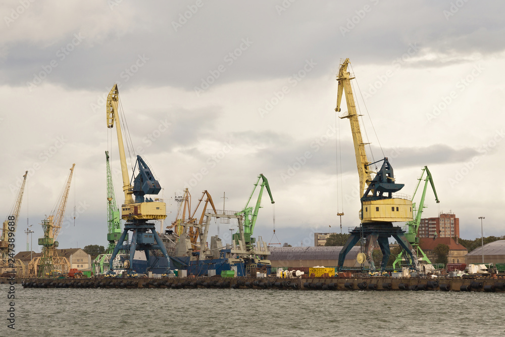 Heavy harbor jib cranes in the Klaipeda Sea Port, Lithuania. Heavy harbor jib cranes in the Klaipeda Sea Port, Lithuania.