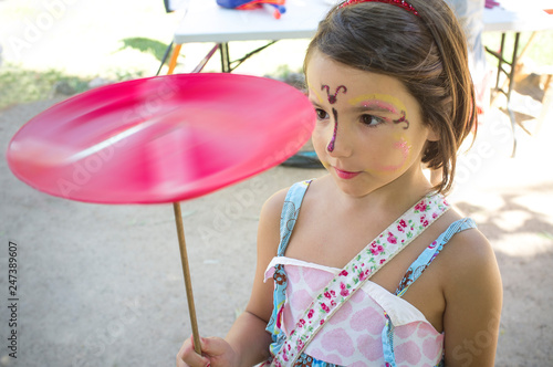Fotografie Child girl playing with spinning plate