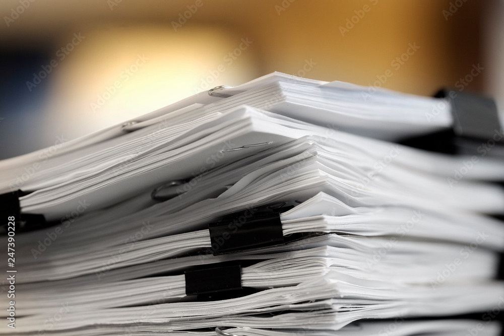 Fotografie Pile of Papers with Binder Clips for Organizing