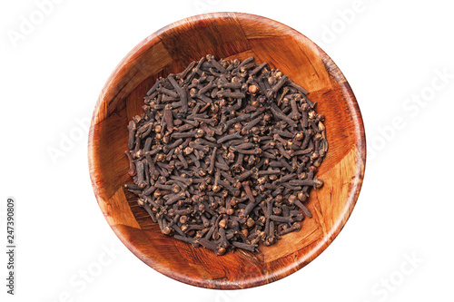 Cloves in brown wooden bowl isolated on white empty copy space. 