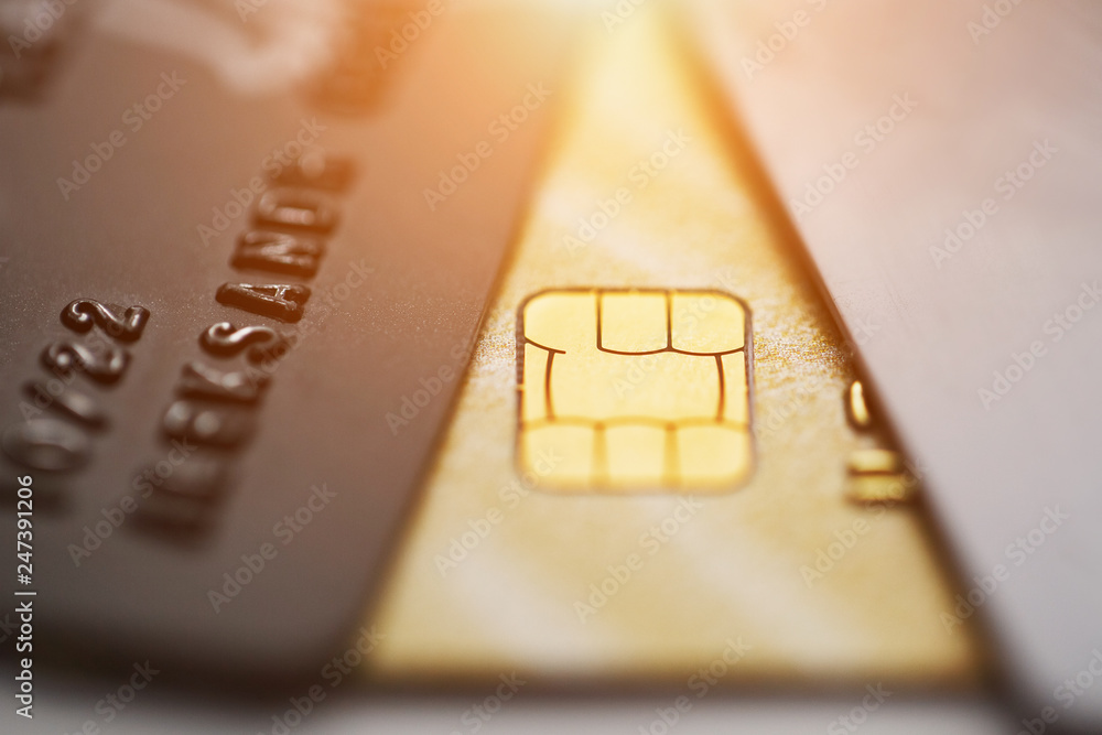 Selective focus microchip on paying by credit card or credit gold card for background. Contactless payments.