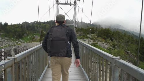 172 Hanging metallic bridge hiker male walking slow mo