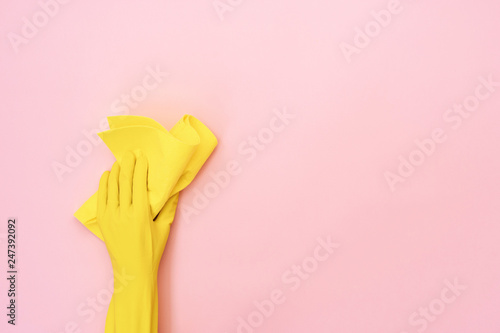 Woman holding yellow cleaning towel in her hands