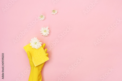 Woman holding sponge for washing with white flowers in her hands