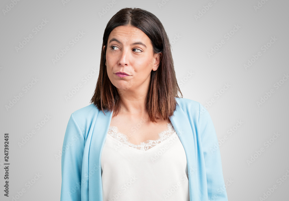 Middle aged woman doubting and confused, thinking of an idea or worried about something Middle aged woman doubting and confused, thinking of an idea or worried about something