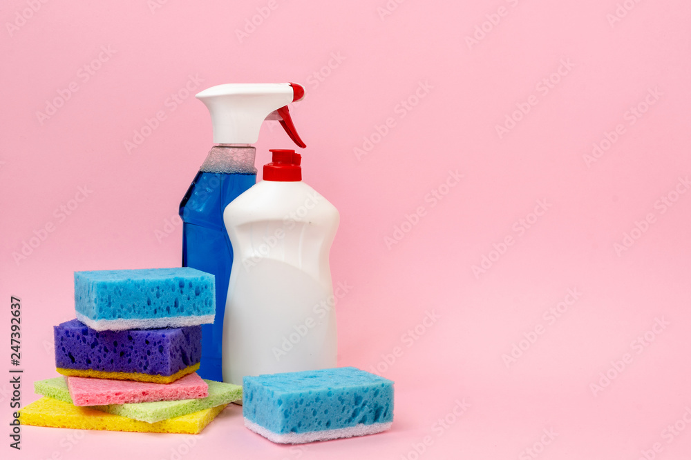 Detergent spray bottle standing near cleaning soap and sponges Detergent spray bottle standing near cleaning soap and sponges