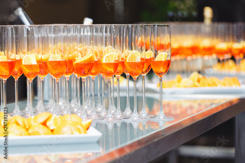 Beautifull Champagne glasses on light white background with orange. Party and holiday celebration concept