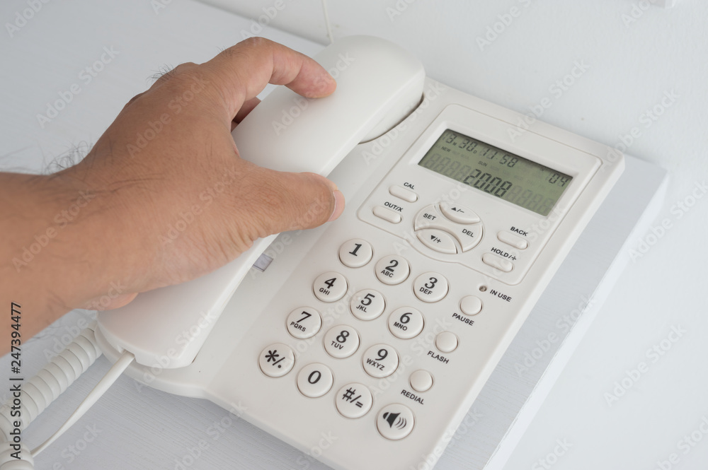 A man holding telephone receiver. A man holding telephone receiver.