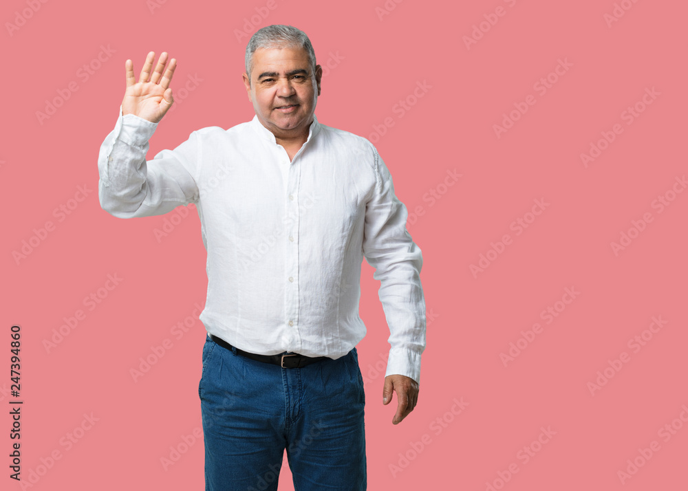Middle aged man showing the number four, symbol of counting, concept of mathematics, confident and cheerful Middle aged man showing the number four, symbol of counting, concept of mathematics, confident and cheerful