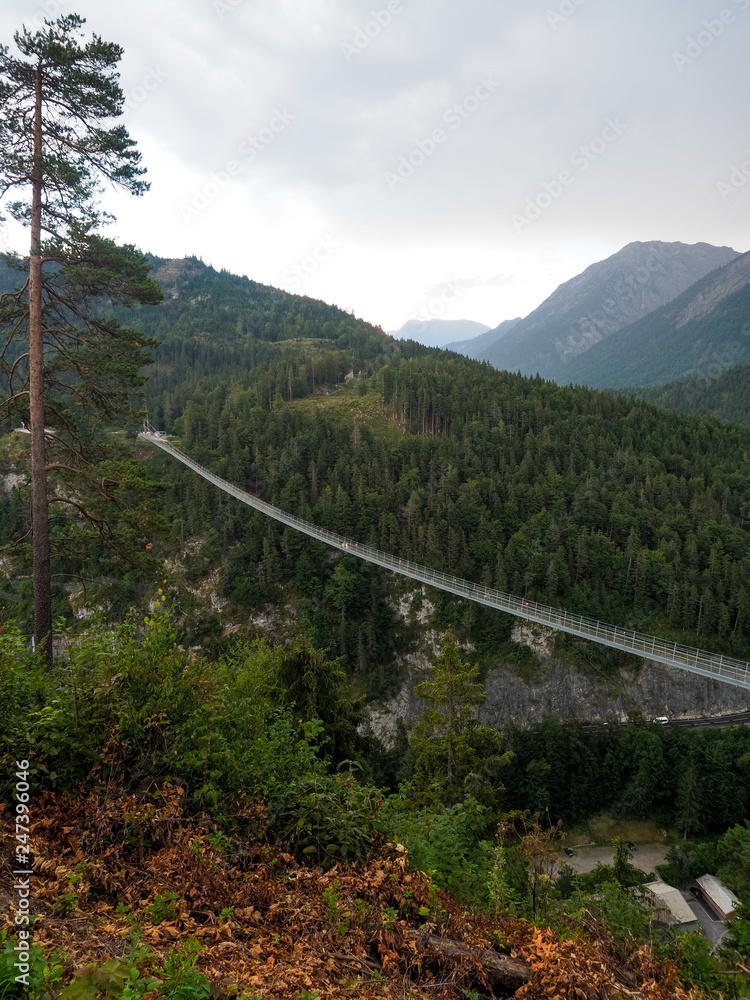 Reutte, Tyrol, Austria - August, 2018 2018: Highline 179 in Reutte, longest 406 meters rope pedestrian bridge in the world. Connects Ehrenberg Ruins and Fort Claudia. Reutte, Tyrol, Austria - August, 2018 2018: Highline 179 in Reutte, longest 406 meters rope pedestrian bridge in the world. Connects Ehrenberg Ruins and Fort Claudia.