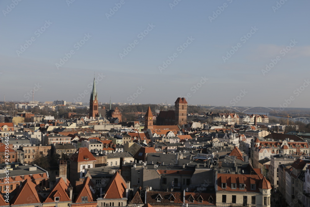 A view from the tower of the town hall in Torun. Visible Gothic buildings of the Old Town, New Town with the church of St. James, tenement houses, roofs covered with tiles. UNESCO heritage.