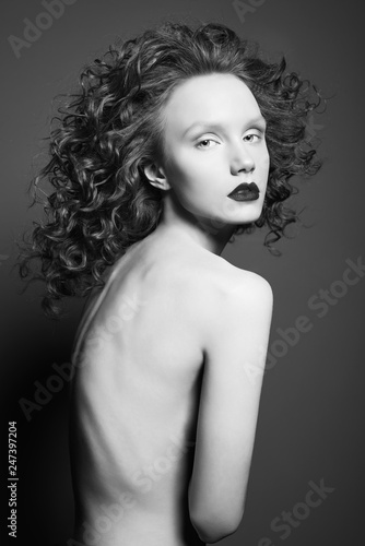 Beautiful nude woman with curly-hair and black lips. © Egor Mayer