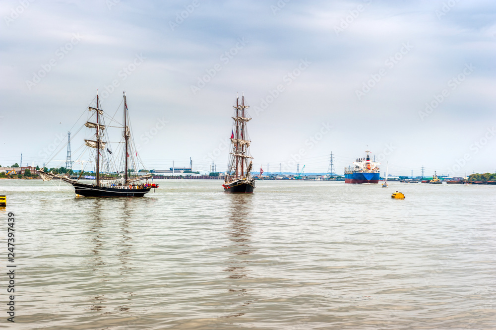 Fototapeta premium Tall Ship passing a tanker in the Tall Ships Regatta in London