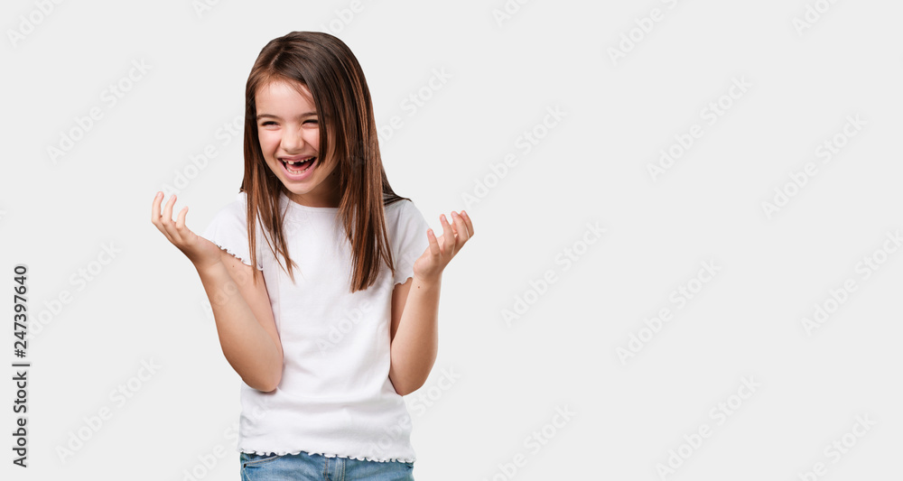 Full body little girl laughing and having fun, being relaxed and cheerful, feels confident and successful Full body little girl laughing and having fun, being relaxed and cheerful, feels confident and successful