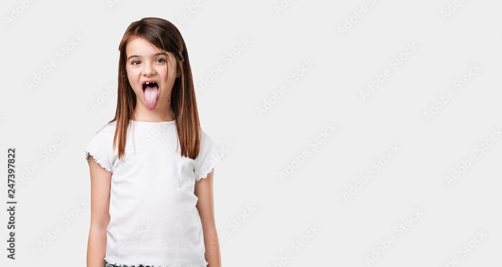 Full body little girl expression of confidence and emotion, fun and friendly, showing tongue as a sign of play or fun Full body little girl expression of confidence and emotion, fun and friendly, showing tongue as a sign of play or fun