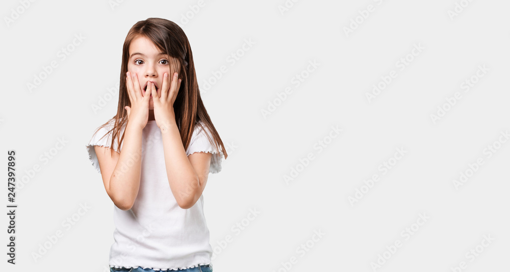 Full body little girl surprised and shocked, looking with wide eyes, excited by an offer or by a new job, win concept Full body little girl surprised and shocked, looking with wide eyes, excited by an offer or by a new job, win concept