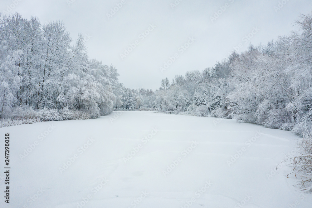 Aerial view of winter beautiful landscape with trees covered with hoarfrost and snow. Winter scenery from above. Landscape photo captured with drone. Aerial view of winter beautiful landscape with trees covered with hoarfrost and snow. Winter scenery from above. Landscape photo captured with drone.