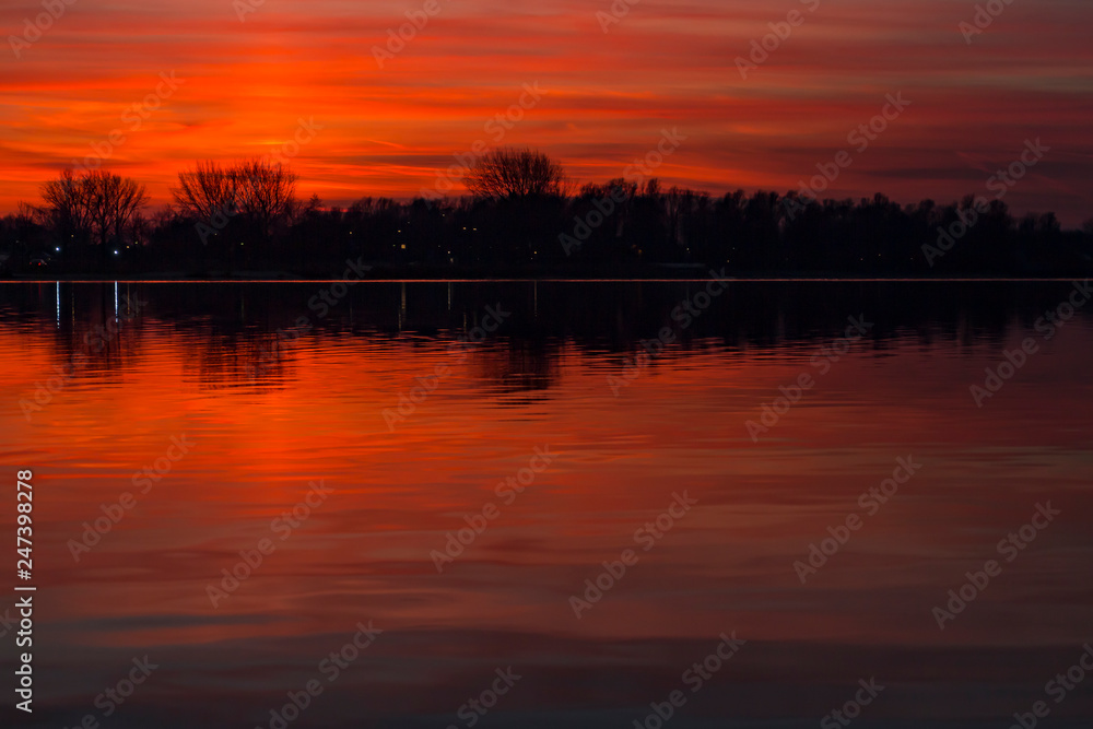 Obraz premium The ever changing pearly sky is beautifully reflected in the water of the Lake Zoetermeerse plas, Netherlands