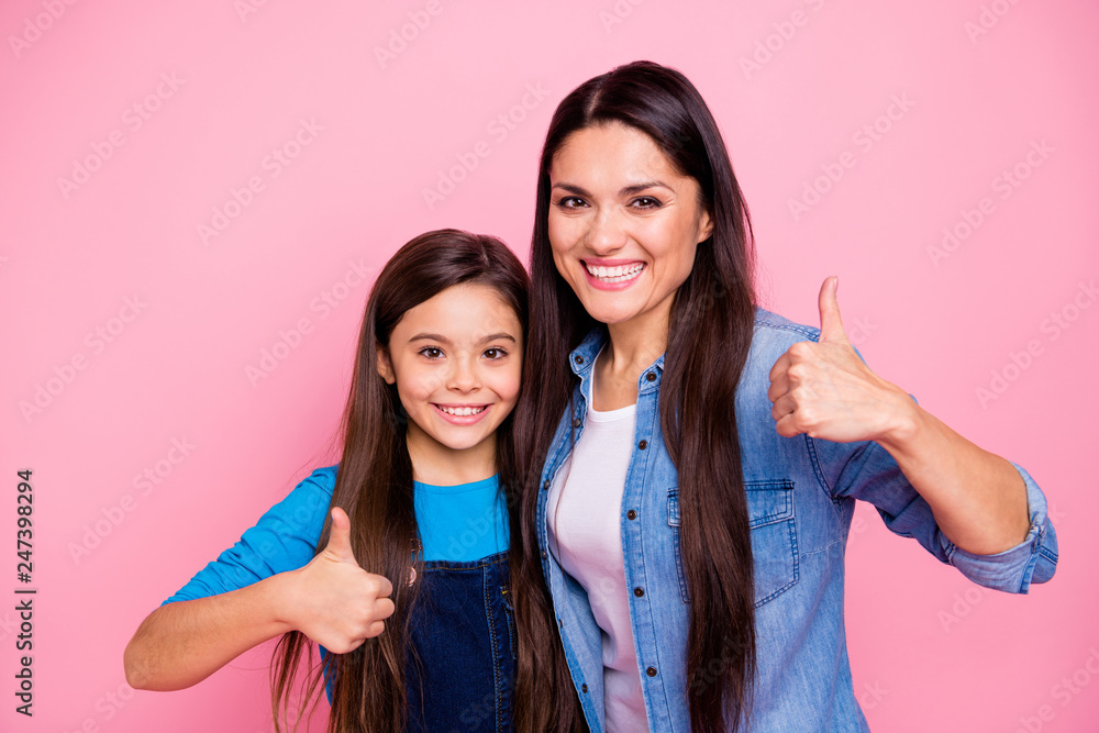 Portrait of two nice cute sweet winsome lovely fascinating attractive charming cheerful cheery positive girls showing thumbup ad advert isolated over pink pastel background Portrait of two nice cute sweet winsome lovely fascinating attractive charming cheerful cheery positive girls showing thumbup ad advert isolated over pink pastel background